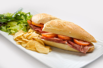 Serrano ham sandwich accompanied by potatoes