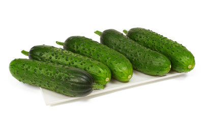 Cucumbers on plate on white background, isolated