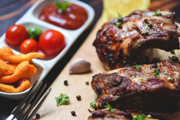 bbq pork ribs grilled with tomatoes ketchup and herbs spices served on the table - Roasted barbecue pork spare rib sliced