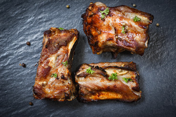 bbq pork ribs grilled with herbs spices served on the dark plate - Roasted barbecue pork spare rib sliced