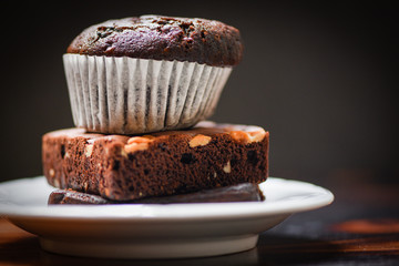 chocolate cupcake on the Chocolate Brownie on white palte with dark