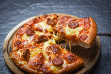 Pizza slice on wooden tray / delicious tasty fast food italian traditional pizza cheese