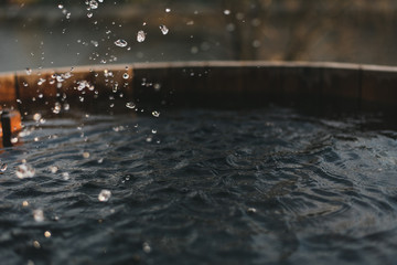 Spray clean water in a well filled. Wooden well with water.