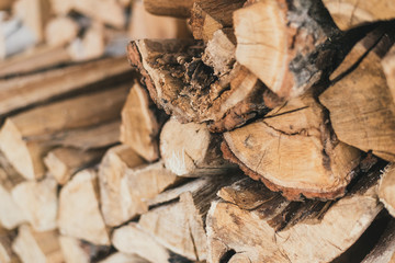 Chopped wood in the stack. Wooden firewood logs superimposed on each other.