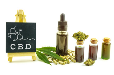 CBD oils, flower buds and pills with small blackboard with Cannabidiol molecular structure