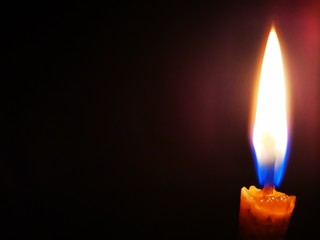 Closeup with candle light in the dark.