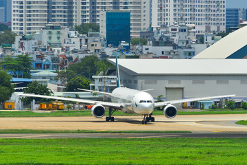 Fototapeta na wymiar Airplane taxiing on runway of the airport
