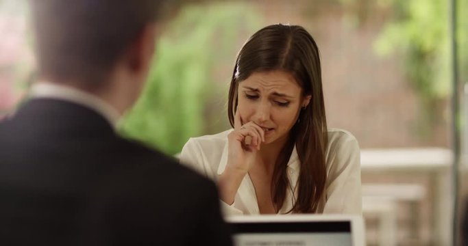 4K Emotional businesswoman crying in a meeting with her boss. Slow motion.