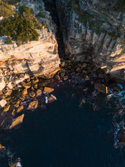 Top down aerial view of coastline with gully opening.