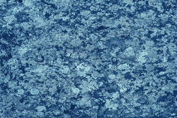 Vintage blue background. Rough painted wall of sapphire color. Imperfect plane of blue colored. Uneven old decorative toned backdrop of cyan tint. Texture of sapphirine hue. Ornamental stony surface.
