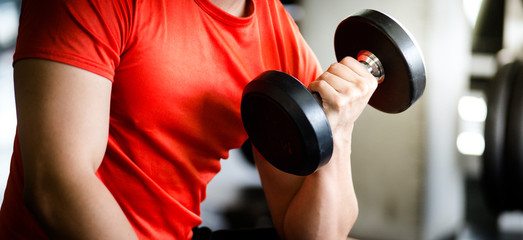 Fototapeta na wymiar A young man from ASEAN, Asia, Europe, exercising, practicing gym with dumbbells, close-ups, men sitting on a Exercise weight bench with dumbbells and dumbbells, lifting dumbbells up and down