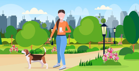 woman walking with dog using smartphone social media network communication digital gadget addiction concept city urban park landscape background flat full length horizontal