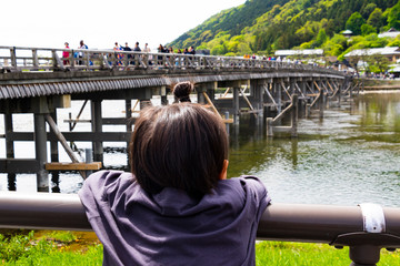 Children looking at the Katsura River in Arashiyama, Kyoto, Japan