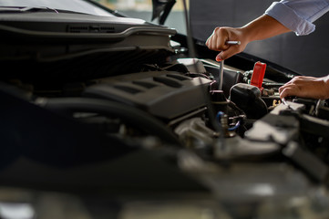 Fototapeta na wymiar Repair service car Auto mechanic working in garage car mechanic with wrench in garage