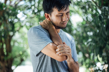 Pain in elbow , Asian young men with elbow pain, health care concepts, Health Care Concept