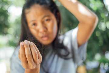 Young asian woman looking lost hair in hand . problem lost hair 