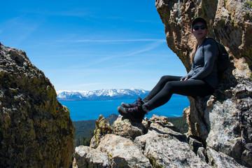 Woman on a mountain looking down at Lake Tahoe