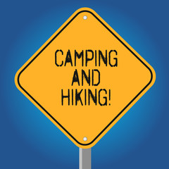 Handwriting text Camping And Hiking. Concept meaning outdoor activity involving staying away from home Blank Diamond Shape Color Road Warning Signage with One Leg Stand photo