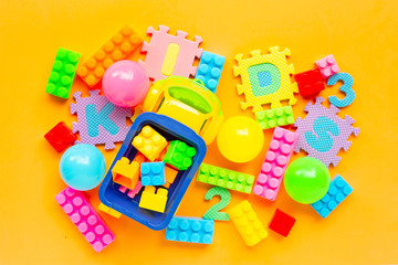 Colorful Kids toys with alphabet "KIDS" Puzzle Pieces on yellow background