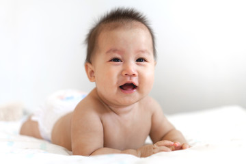 Portrait of happy smile baby relaxing on the bed