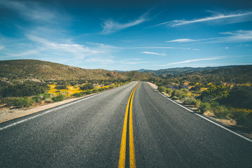 Long desolate highway road through California's desert 