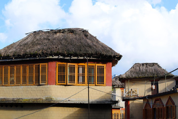 Fototapeta na wymiar Houses in a village near the rice fields of Yunnan, China. The famous terraced rice fields of Yuanyang in Yunnan province in China. Yunnan, China - November, 2018.