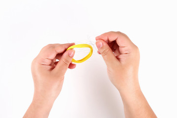 The girl holds a comb and lost hair on a white background. Top view.