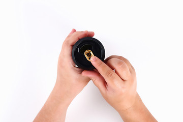 Girl opens aluminum can on white background. Top view.