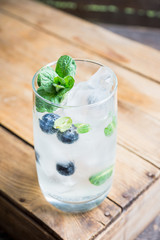 Blueberry mojito cocktail on the wooden background. Selective focus. Shallow depth of field.