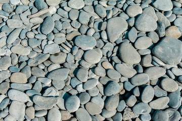 Pebble beach on a sunny summer day, background, selective focus