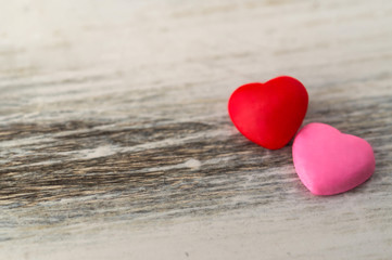 Fototapeta premium Colorful red and pink hearts against rustic white background. Concept of love, Saint Valentine day, healthy lifestyle, heart disease, and relationships