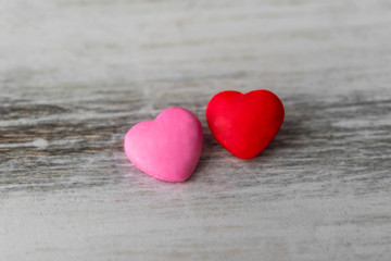 Colorful red and pink hearts against rustic white background. Concept of love, Saint Valentine day, healthy lifestyle, heart disease, and relationships