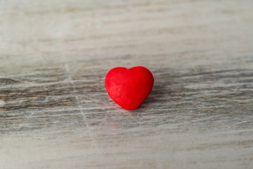 Fototapeta premium Colorful red and pink hearts against rustic white background. Concept of love, Saint Valentine day, healthy lifestyle, heart disease, and relationships