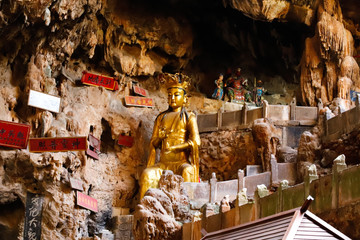 A statue of a god in Jianshui Swallow Cave in Yunnan province, China. Yunnan, China - November, 2018