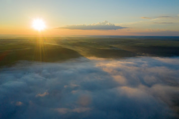 Canyon river in fog shooting from the air