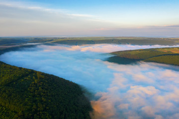 Fototapeta premium Canyon river in fog shooting from the air