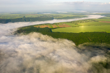 Canyon river in fog shooting from the air