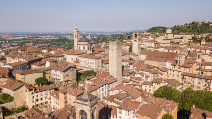 Fototapeta na wymiar Bergamo, Italy. Amazing drone aerial view of the old town. Landscape at the city center, its historical buildings and the towers