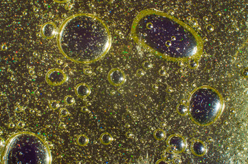 Abstract golden background transparent slime with particles and bubbles