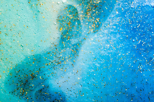 Background transparent slime with golden glitter