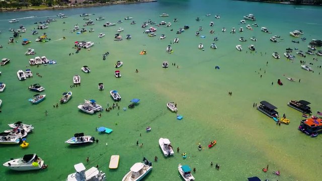 Boats, jet skis, and kayaks anchored at Haulover Sandbar in North Miami's intracoastal waterway.