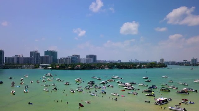Boats, jet skis, and kayaks anchored at Haulover Sandbar in North Miami's intracoastal waterway.