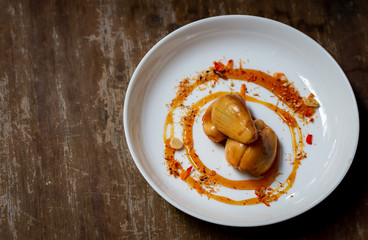 Salacca with sweet spicy sauce. Salacca or Snakefruit is a species of palm trees native to Southeast Asia and the Eastern Himalayas. It has a sweet and sour taste. 
