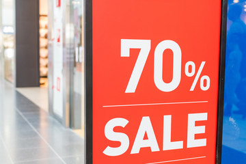Sale label, in a clothes store showcase. Summer sales season.Signboard Summer sale in shop window.Total sale .shopping time cocept.70 off discount promotion sale.