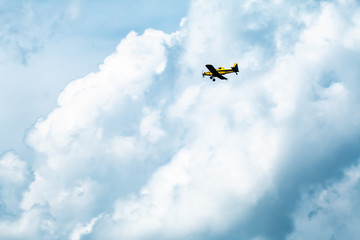 Fototapeta na wymiar Small Yellow Airplane in flight