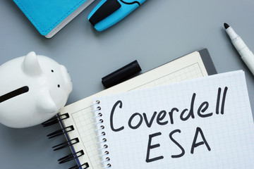 Coverdell ESA Education Saving Account. Note pad and piggy bank.