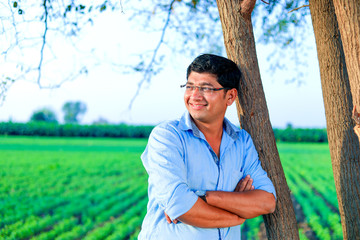 Young indian farmer at field