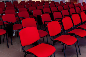 Naklejka premium Conference room with a red stage and chairs