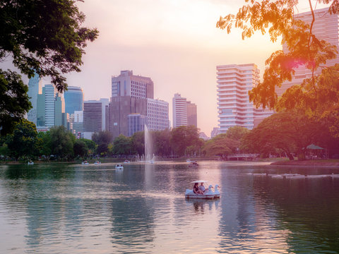 BANGKOK, THAILAND - April 11, 2019: Views of Silom district offices building in the twilight of a cloudy day, Sunset at Suan Lum Phini public park in bangkok.