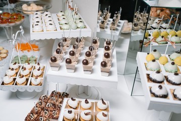 Different fruit desserts with fruits in glasses on the table. Restaurant presentation, food, party concept